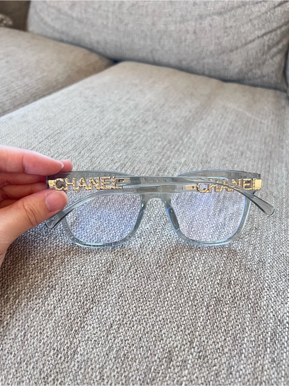 CHANEL Transparent Light Blue Frame Glasses with Gold Logos